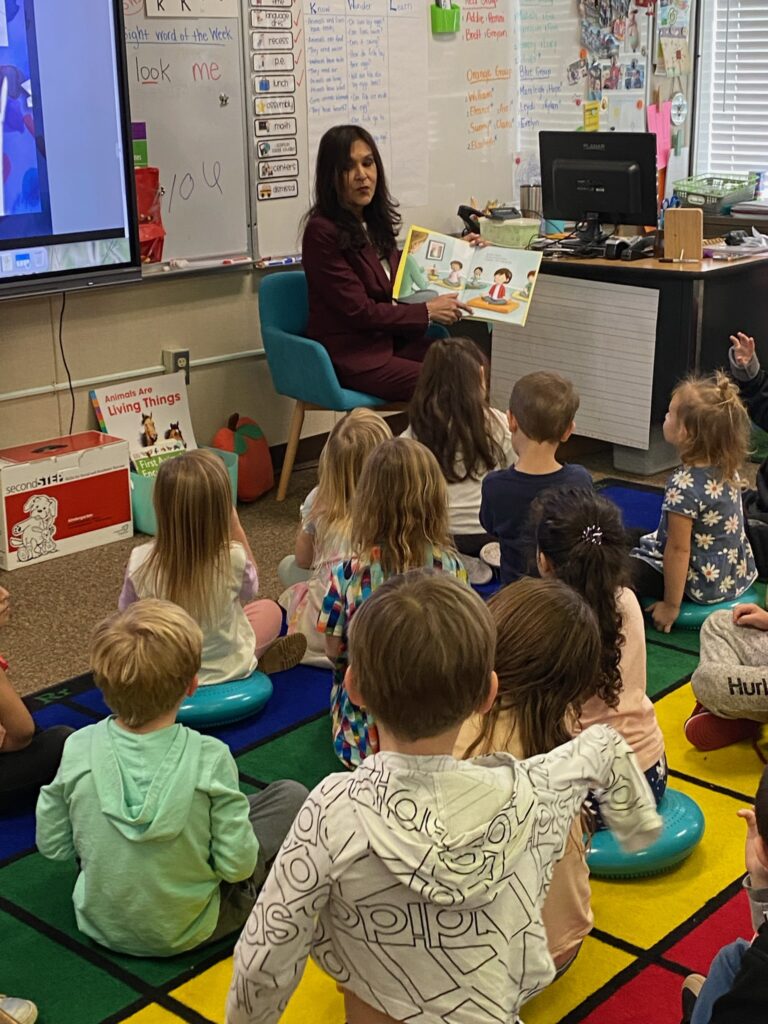 Diana Ramos reads to students at Bend School