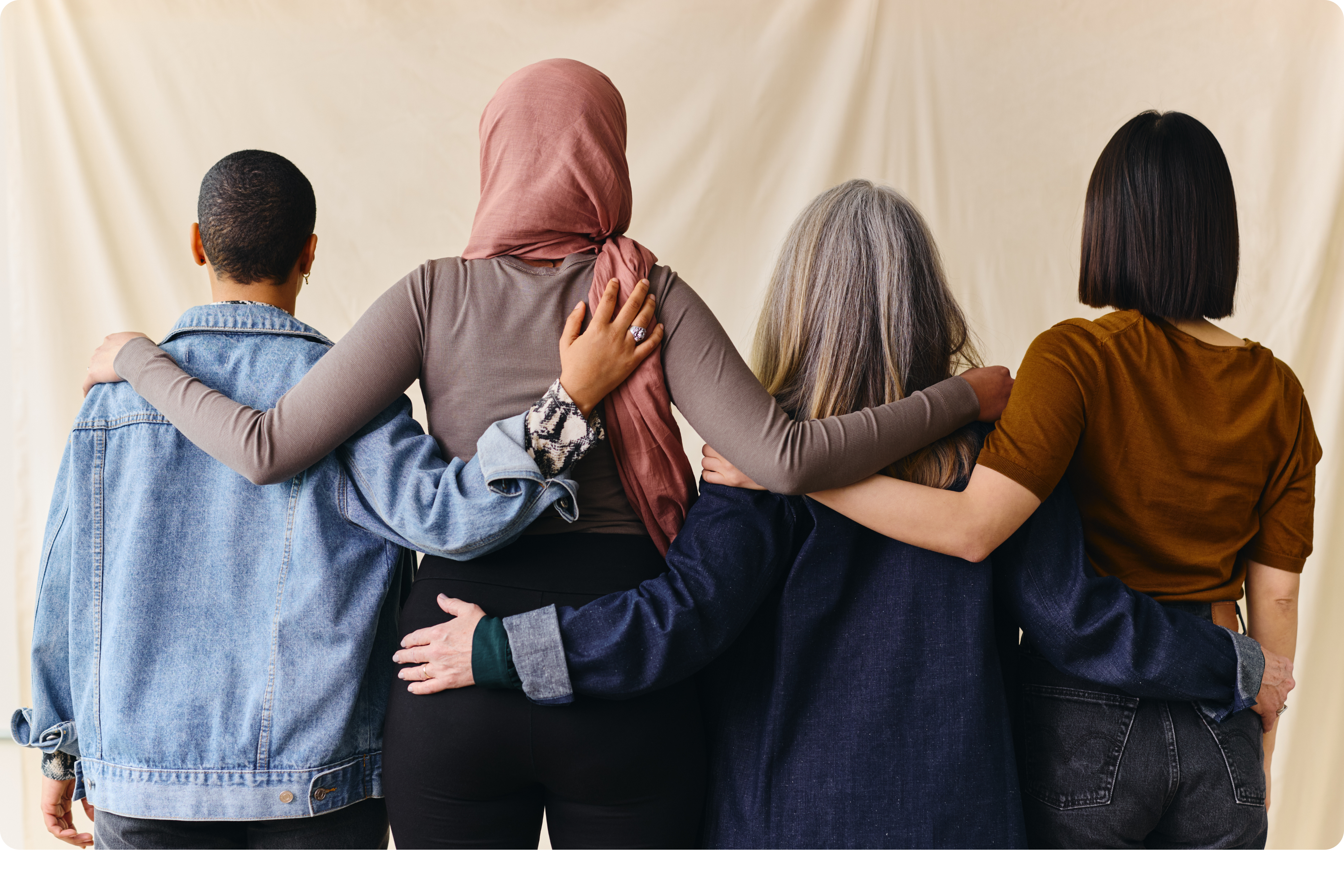 Group of women with arms wrapped around each other's backs