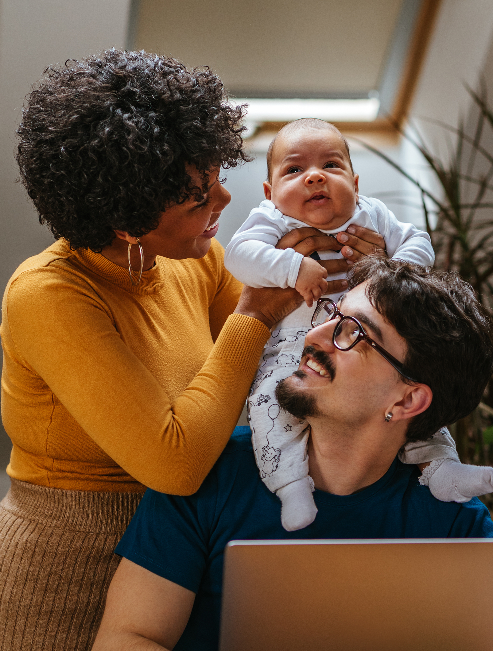 family bonding in home while father works on laptop