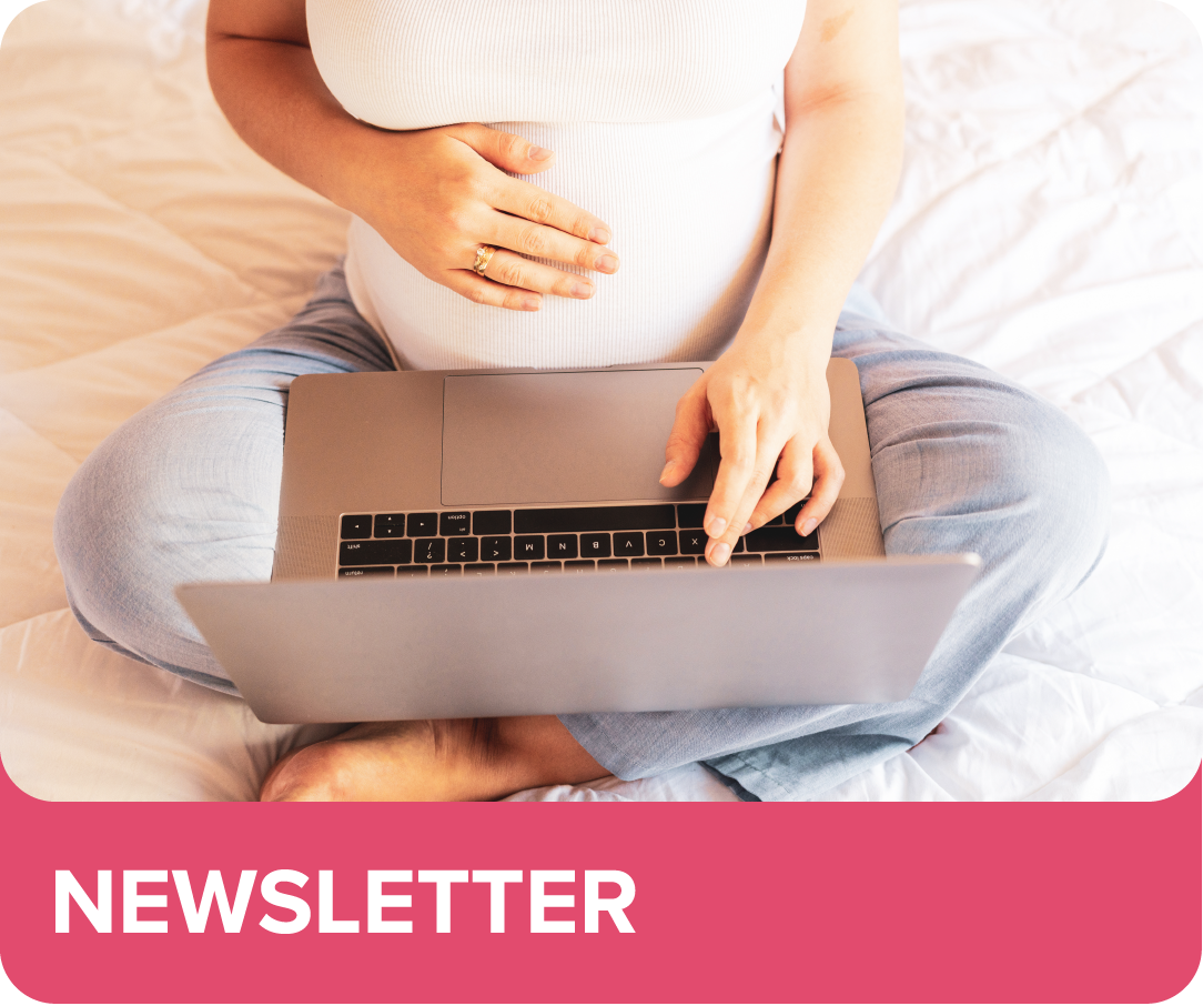 Image of a Woman holding pregnant belly on a lap top looking at eNewsletter.