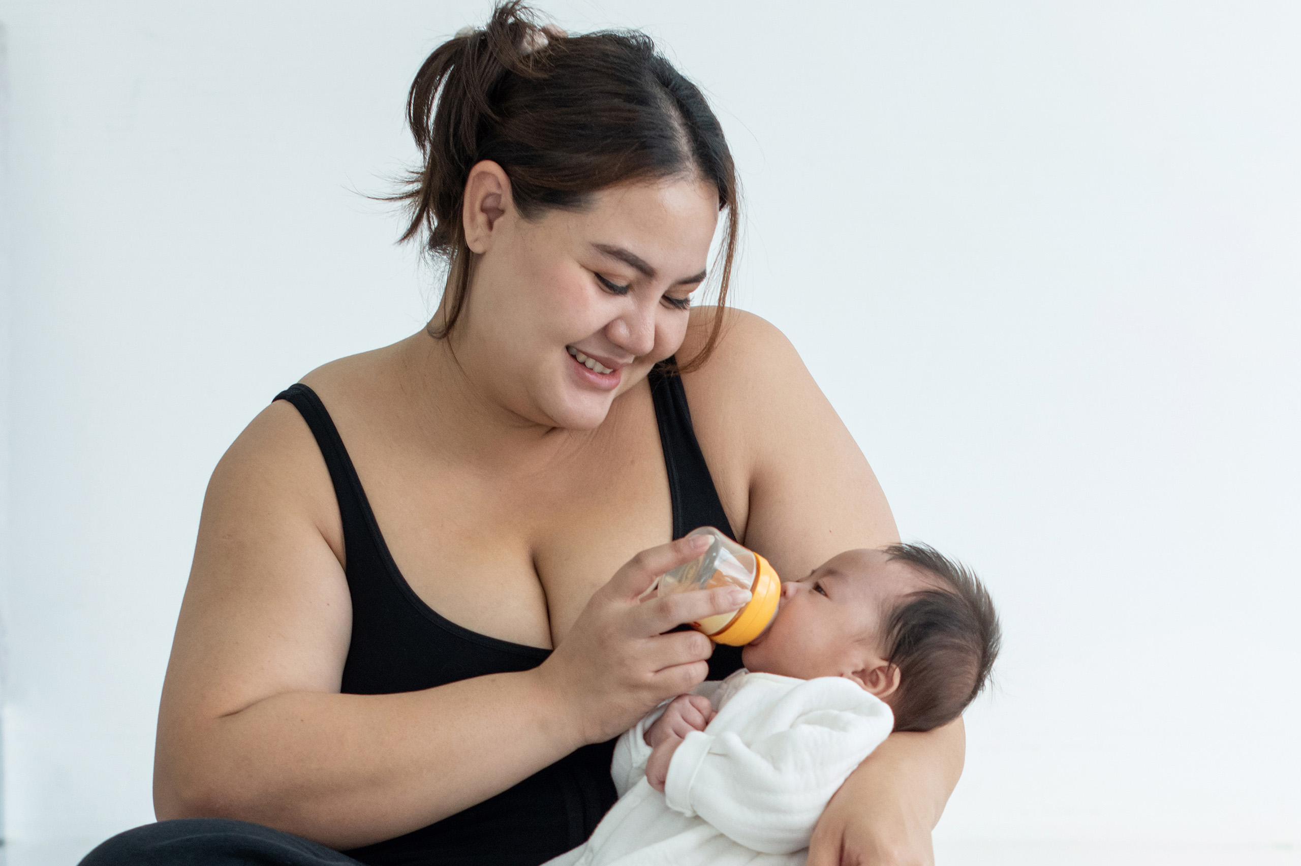 New mother feeding newborn baby
