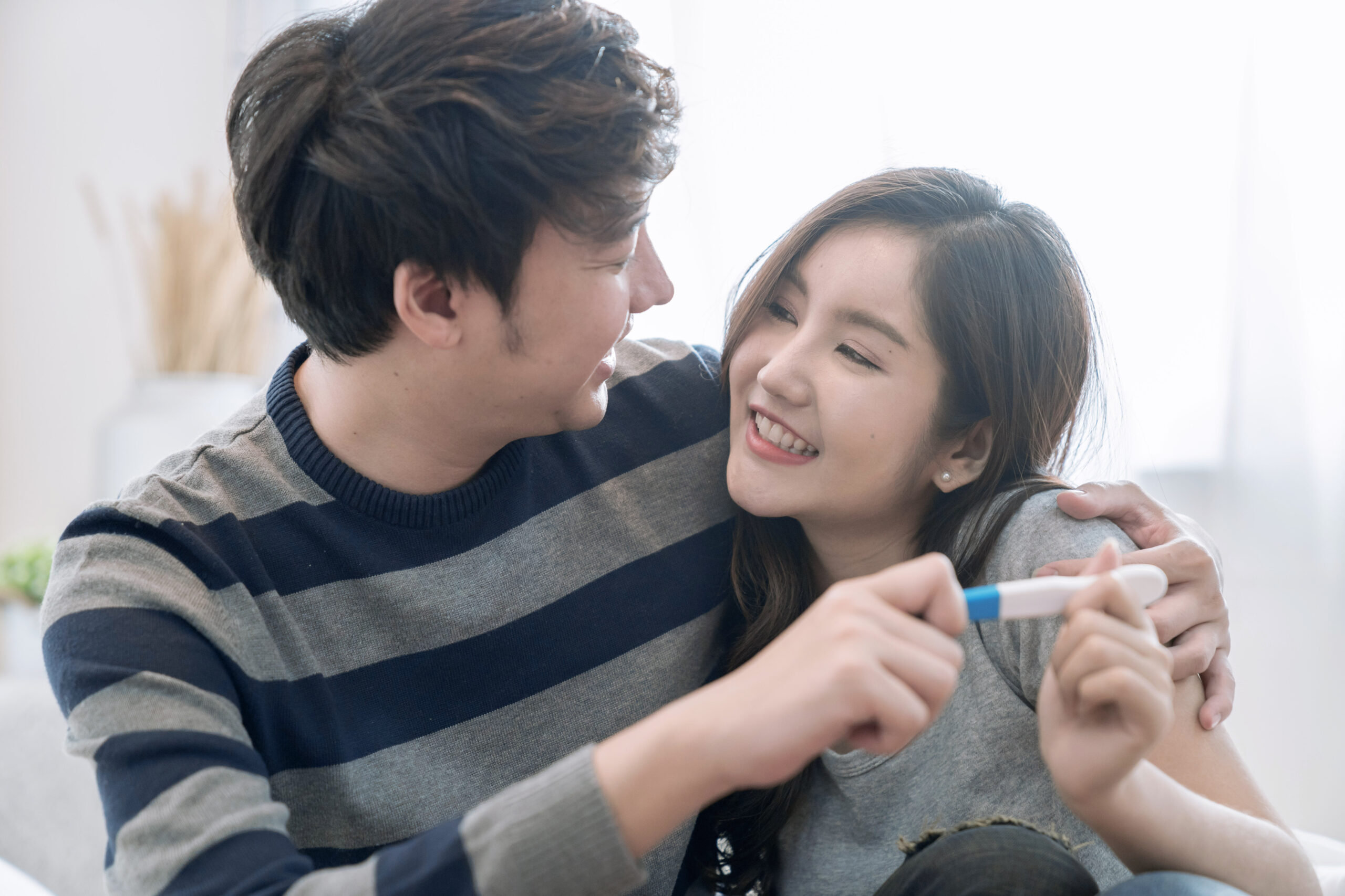 Happy Asian Couple, They were glad to see the results of the pregnancy test, They are going to have children.